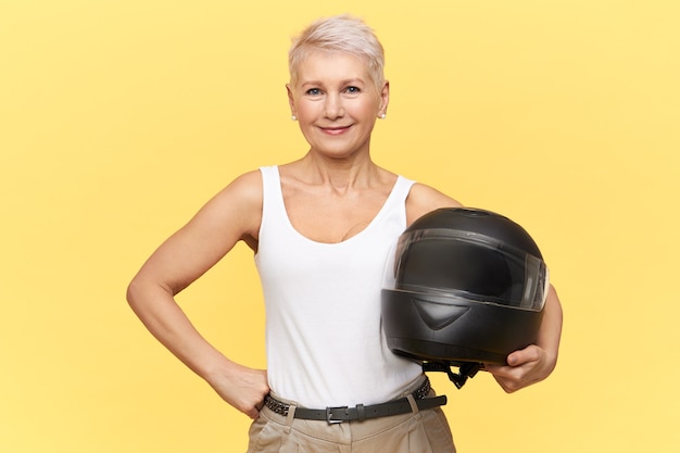 woman stay with black helmet on yellow
