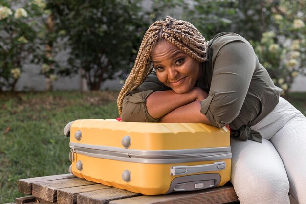 Woman staying on her luggage with her head