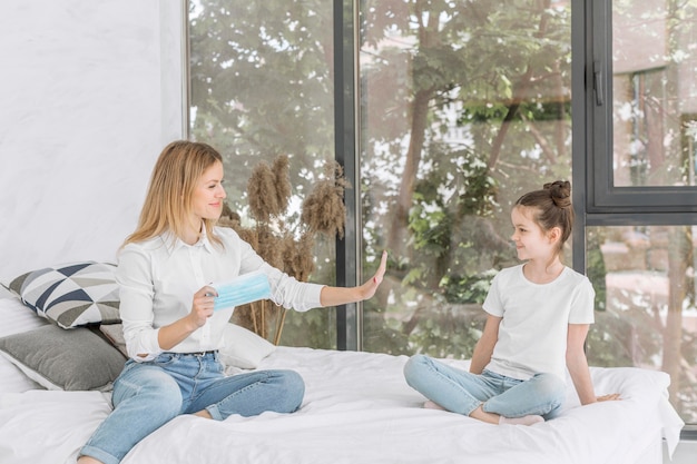 Woman staying with her daughter on the bed