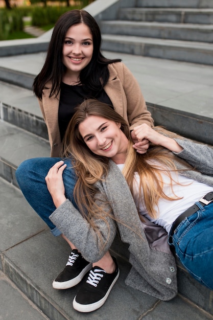 Free photo woman staying with her head on her friends lap