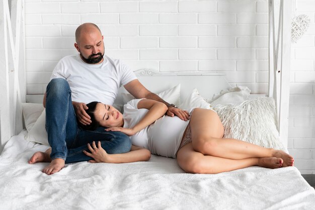 Woman staying with her head on husband's lap 