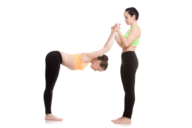 Free photo woman stretching arms of another woman
