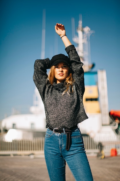 Free photo woman stretching arms in front of ship