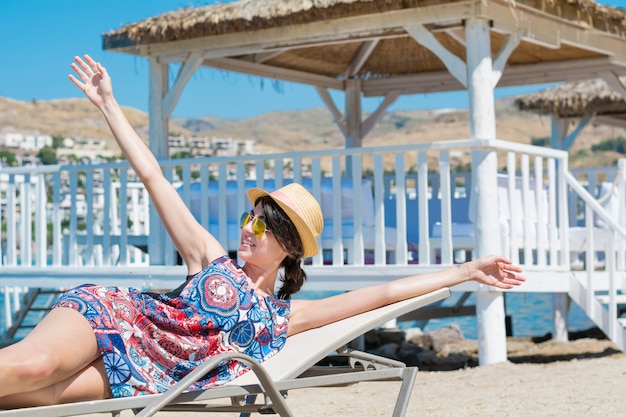 Free photo woman stretching arms while you are lying in a hammock