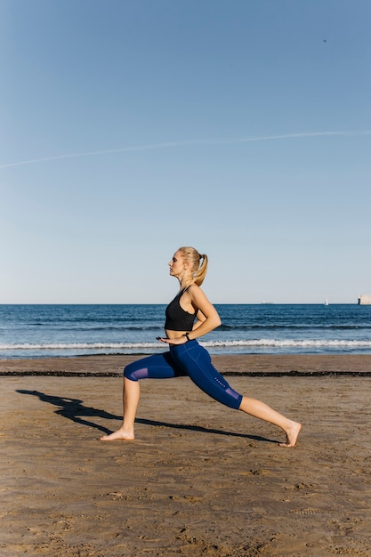 Woman stretching at the beach