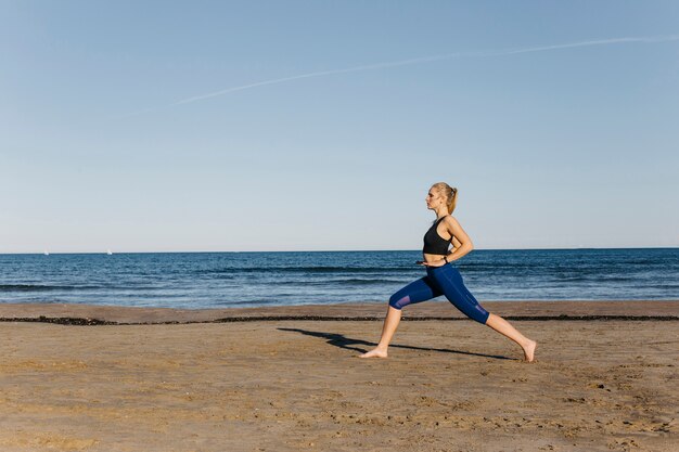 Woman stretching at the beach