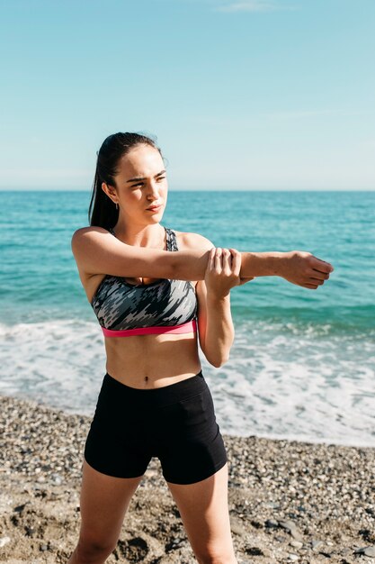 Woman stretching at the beach