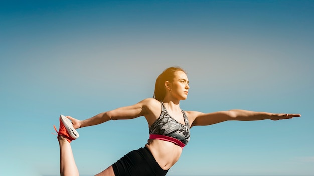 Free photo woman stretching at the beach