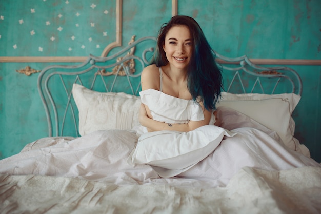 Free photo woman stretching in bed after wake up