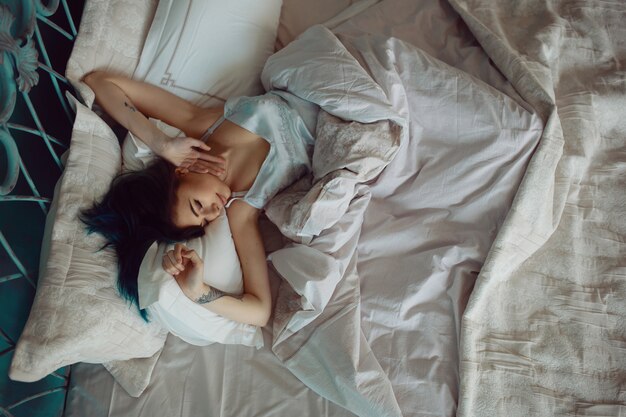 Woman stretching in bed after wake up