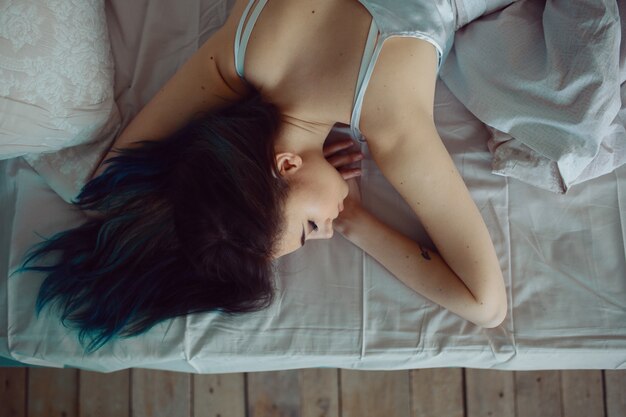 Woman stretching in bed after wake up