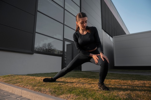 Free photo woman stretching before working out outdoors