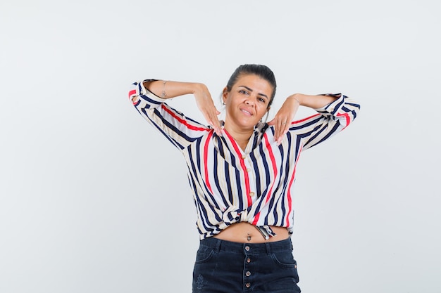 woman stretching elbows in shirt, skirt and looking cute.