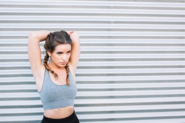 Woman stretching at fence