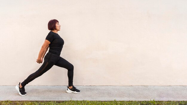 Woman stretching her back outdoors