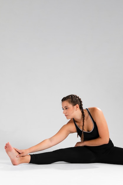 Woman stretching her legs with copy space