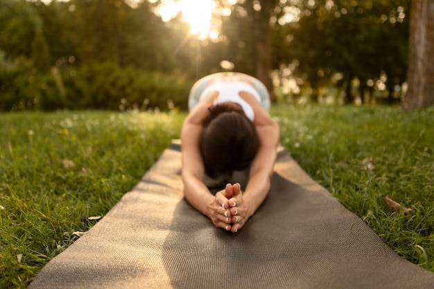 Free photo woman stretching on mat full shot