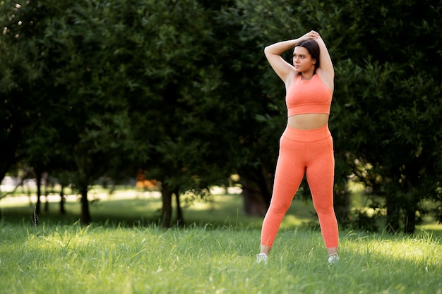 Woman stretching in nature full shot