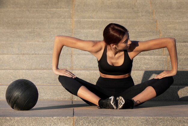 Woman stretching and preparing for exercise outdoors