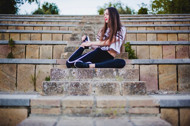 Woman stretching on stairs while meditating