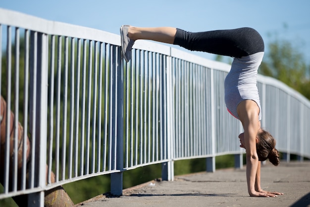 Woman stretching with feet on the railing