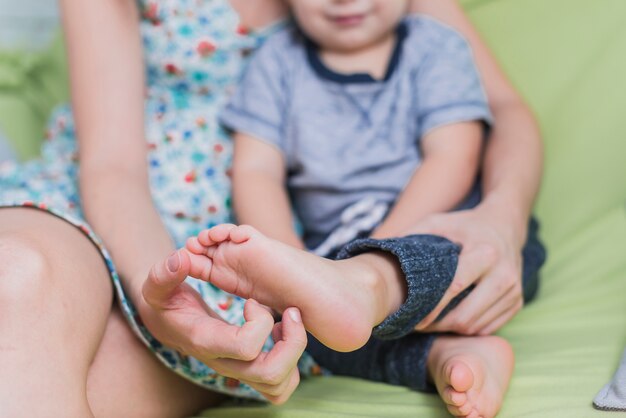 Woman stroking her son's foot