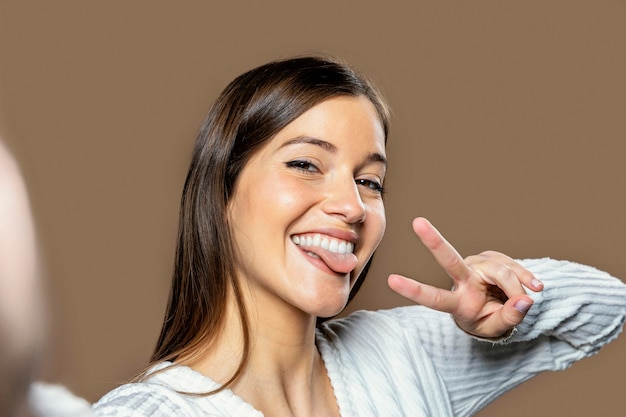 Free photo woman in studio taking a self photo