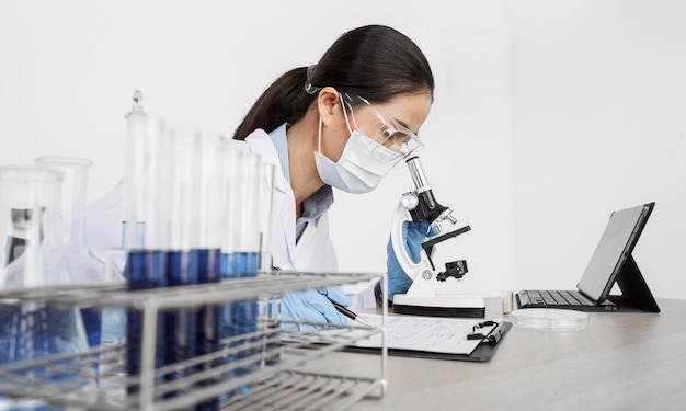 Free Photo woman studying chemical elements indoors