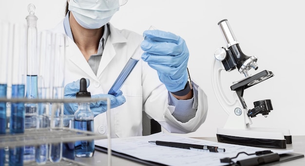 Woman studying chemical elements while wearing a face mask