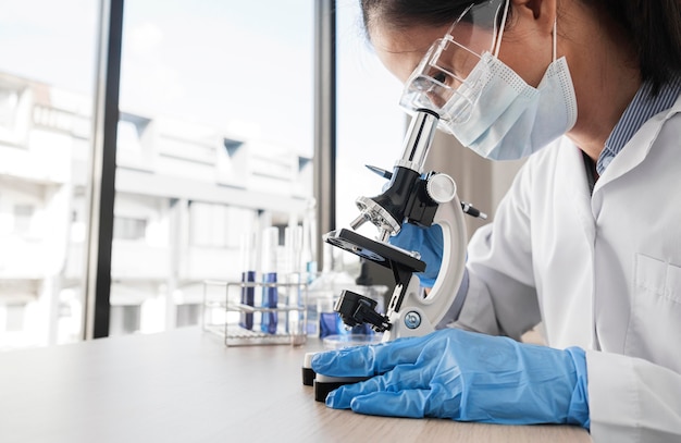 Free Photo woman studying chemical elements with copy space