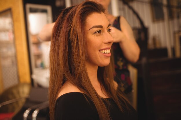 Woman styling her hair at saloon