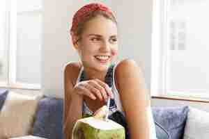 Free photo woman in stylish denim overalls in coffee shop