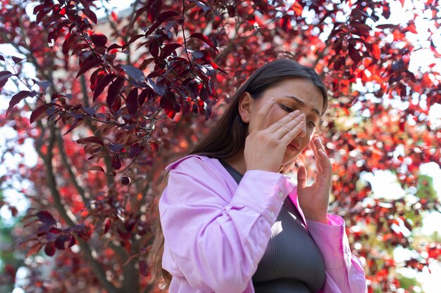 Woman suffering from allergies outside