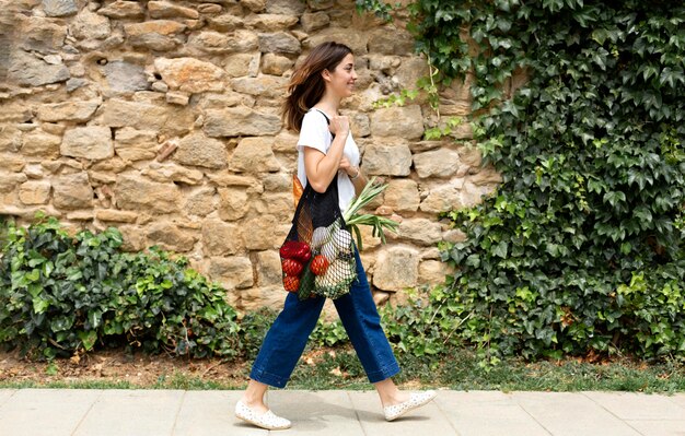 Woman suing a sustainable bag for groceries