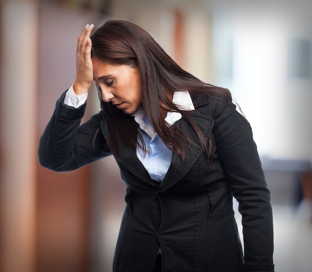 Woman in suit with headache