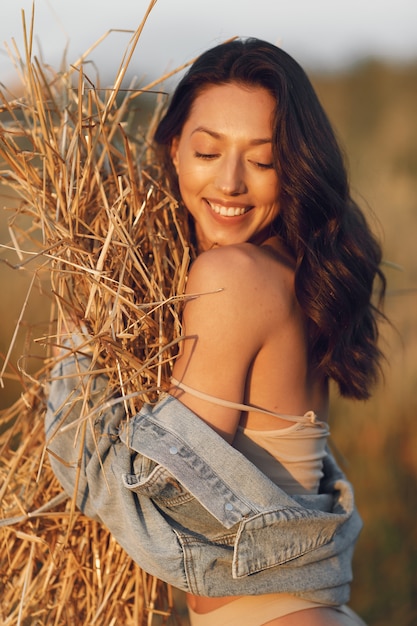 Woman in a summer field. Brunette in a brown underwear. 