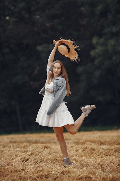 Free photo woman in a summer field. lady in a white dress.