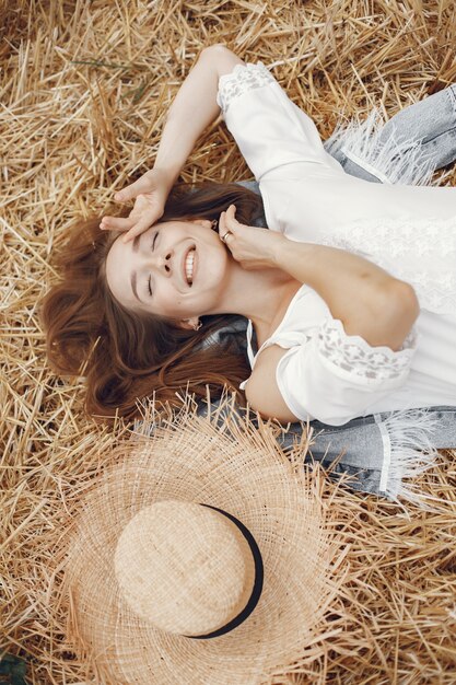 Woman in a summer field. Lady in a white dress. 