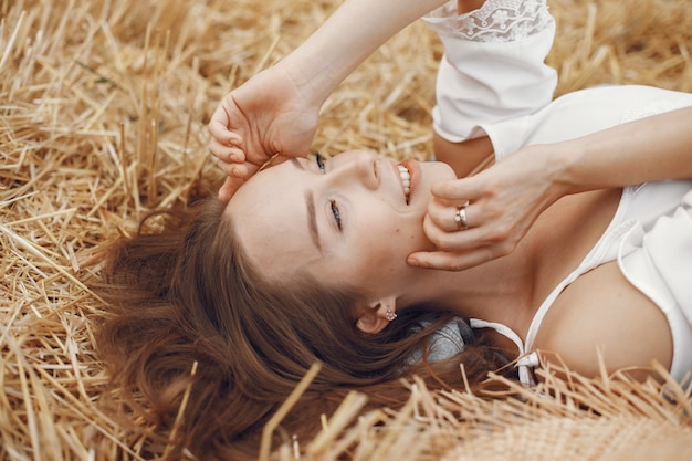 Woman in a summer field. Lady in a white dress. 