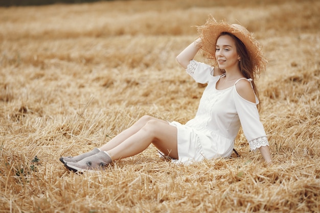 Woman in a summer field. Lady in a white dress. 