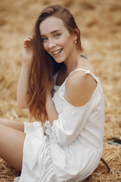 Woman in a summer field. Lady in a white dress. 