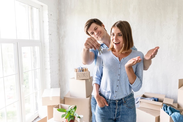 Woman surprised by partner with the keys to their new home