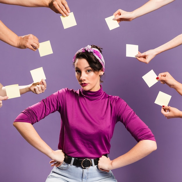 Woman surrounded by hands and sticky notes