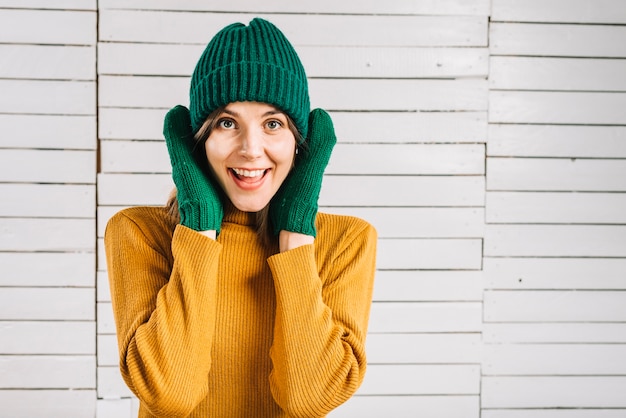 Woman in sweater covering ears