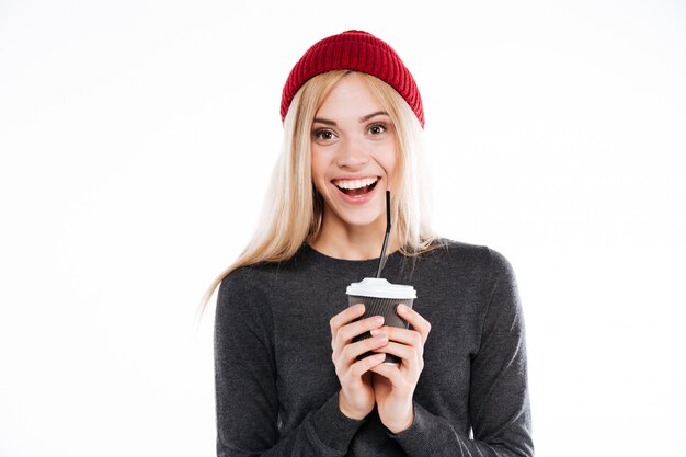 Woman in sweater holding cup of coffee