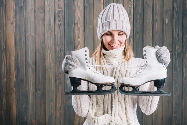 Woman in sweater looking at skates 