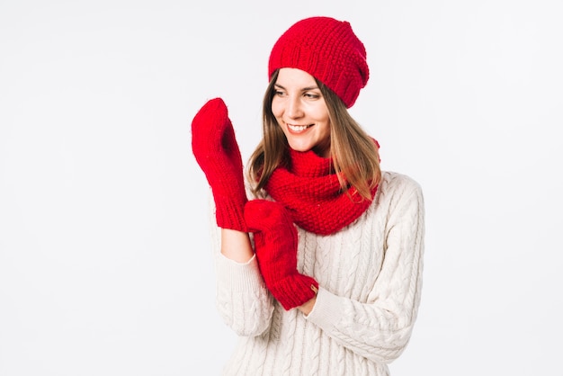 Woman in sweater putting gloves on 