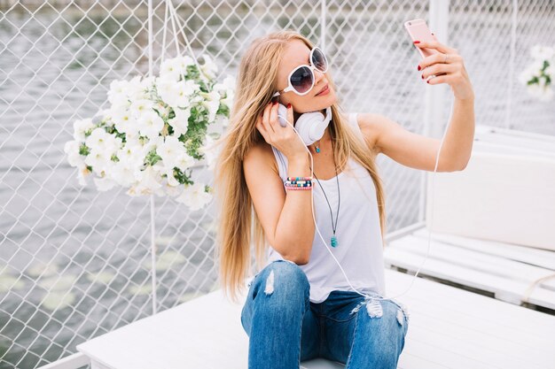 Woman on table taking selfie