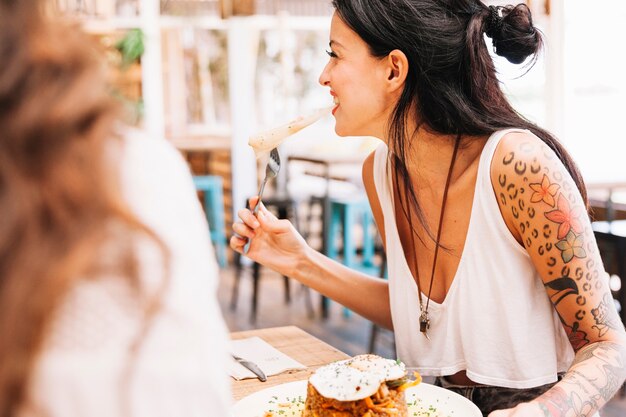 Woman at table talking to friend