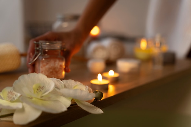 Woman taking the bath salt to put some in the water before taking a bath